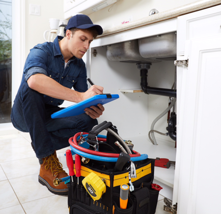 Plumber fixing kitchen leaks in Delray Beach, Florida