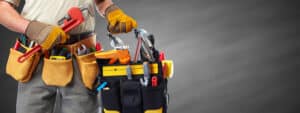 Plumber carrying essential tools for maintenance and repairs.